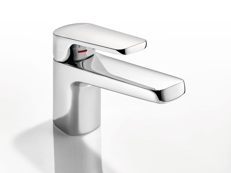 HEWI AQ Single-lever washbasin fitting Chrome-plated tap with a short spout against a smooth white surface