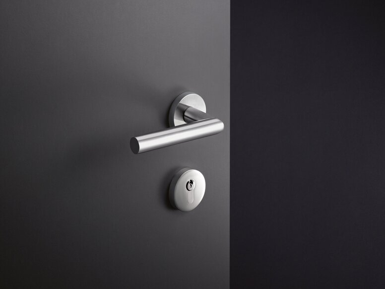 HEWI System 162 lever handle Door handle with a round rose and matching key escutcheon in stainless steel, with a smooth dark grey surface