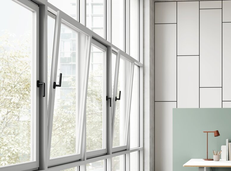 HEWI Range 270 Window Handle Four black window handles on adjacent tilt-and-turn windows in an office