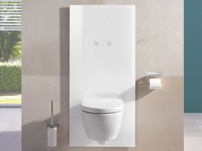 White WC module with integrated cistern control panel, toilet brush holder and toilet roll holder next to the toilet