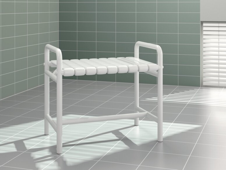A bench with two white synthetic material armrests against a light green tiled wall