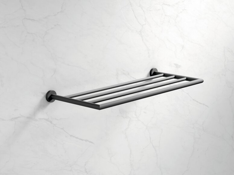 A dark grey powder-coated wall-mounted rail system with four shelves for hanging towels or clothes, set against a white marble background