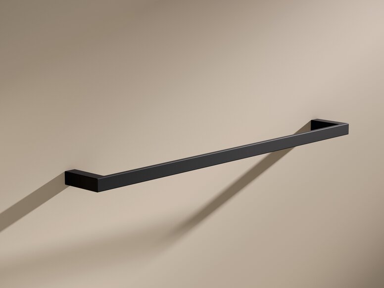 Black powder-coated towel holder with a rectangular cross-section on a beige wall